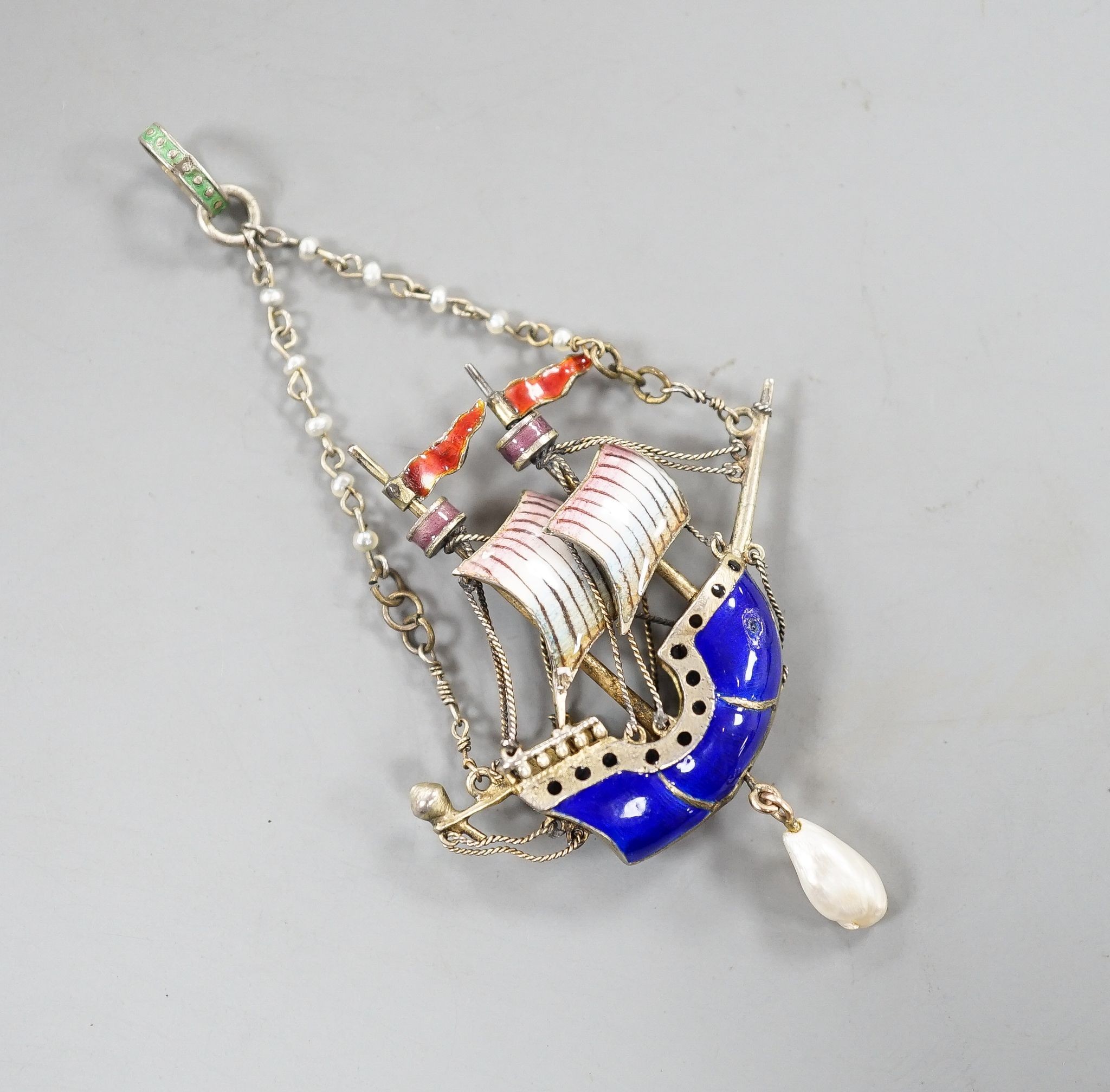 A 20th century continental gilt white metal, polychrome enamel, seed and baroque pearl set 'sailing ship' drop pendant, 48mm.